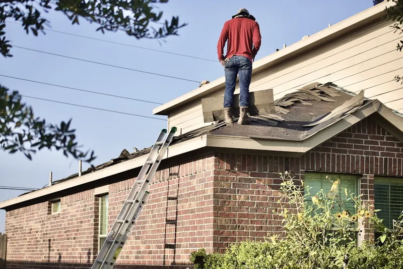 Professional roofer working on a residential roof in Royalton